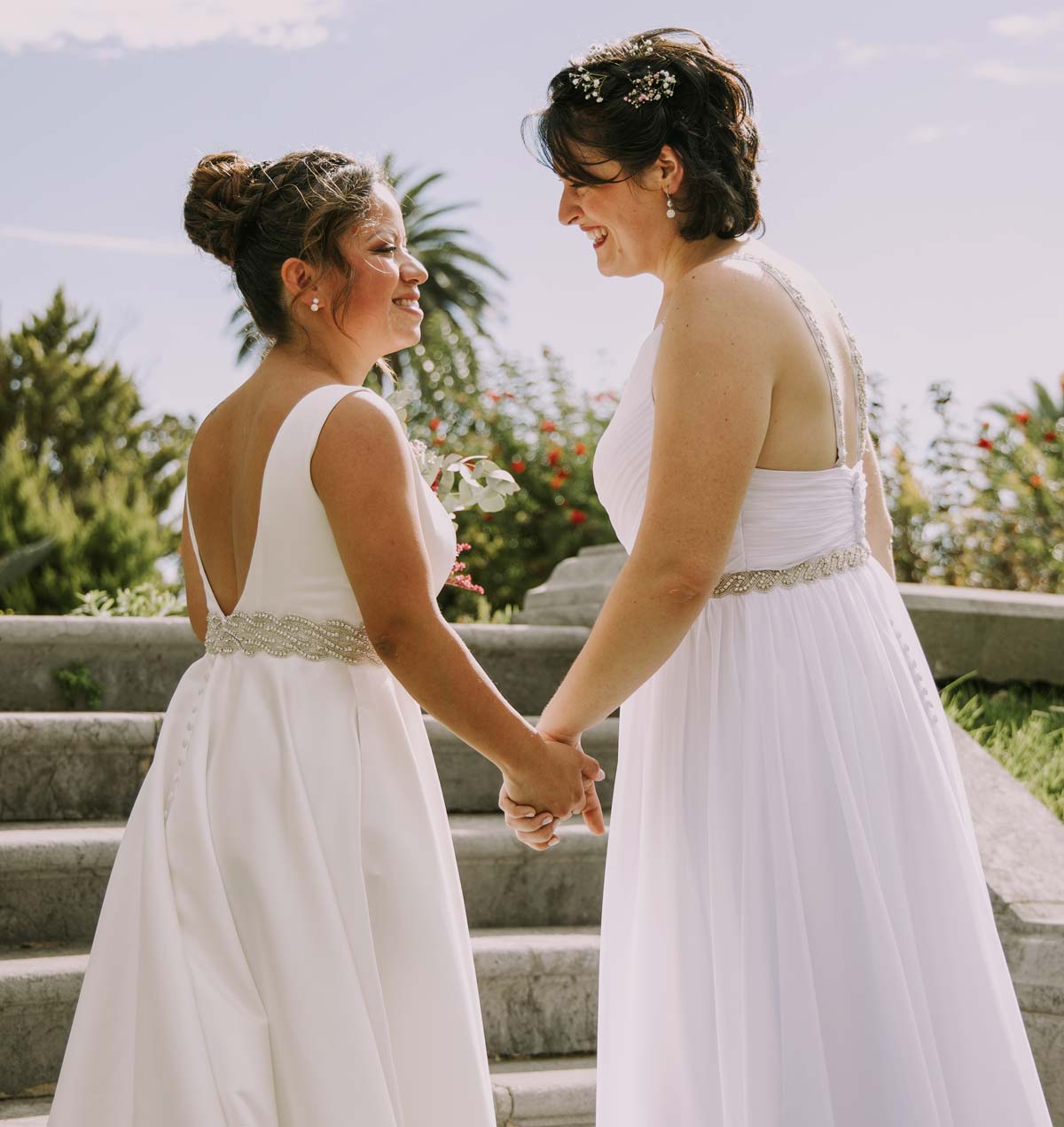 Pareja de novias tomadas de la mano durante una sesión de boda al aire libre en Bilbao
