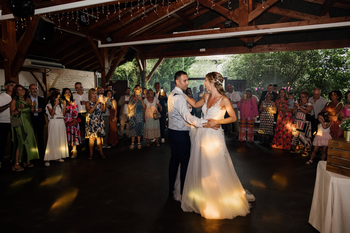 Novios realizando su primer baile rodeados de invitados durante la celebración de boda - fotografía de bodas en Bilbao.