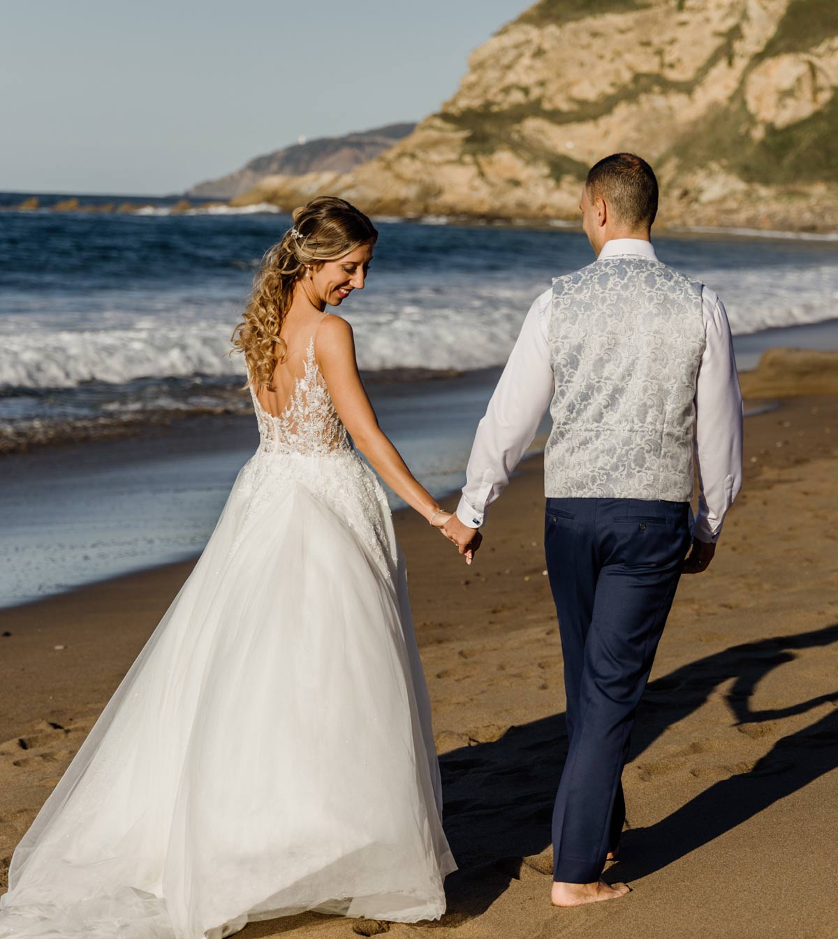Pareja de novios caminando por la playa durante su postboda — Fotógrafo de bodas en Bizkaia.